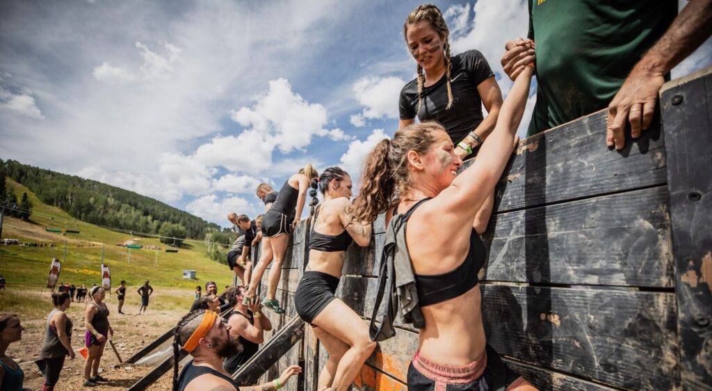 Women climbing the wooden wall